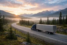 Long-haul truck driving on a Canadian highway at sunrise, featured image for truck driver jobs in Canada with LMIA 2026